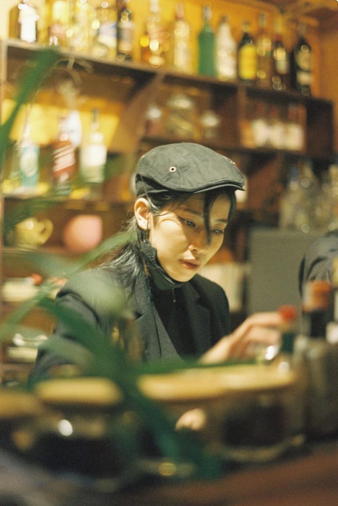 a woman behind a bar