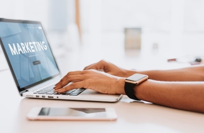 a pair of hands typing on a laptop