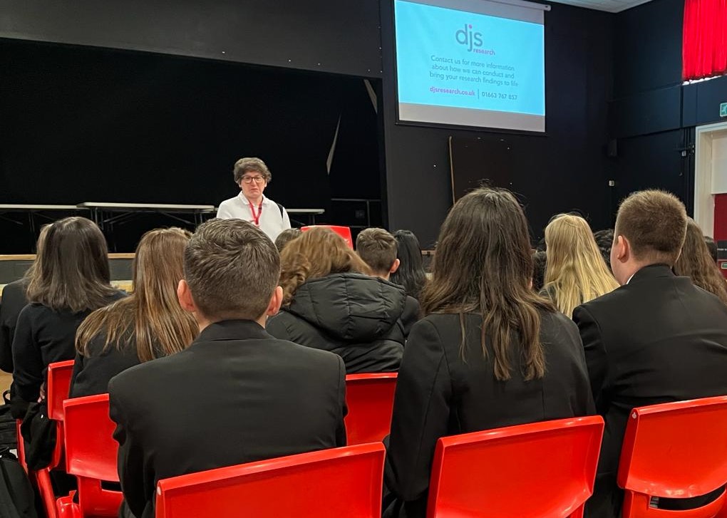 Angharad giving a talk to students at a careers fair.