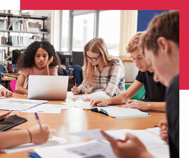 A group of young people studying together in a room.