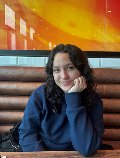 picture of a girl sitting behind a table