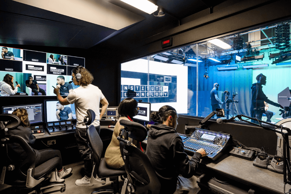 A group of young people working at a GMIOT broadcast media centre.
